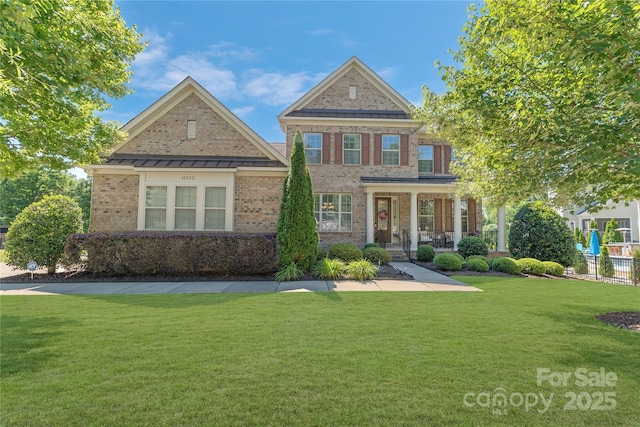 11333 Preservation Ln, Charlotte, NC 28278 - view of front facade featuring brick siding, a front lawn, covered porch, and a standing seam roof