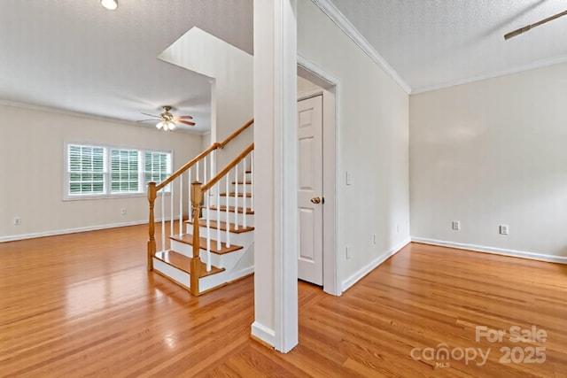 4619 Glasgow Ct, Gastonia, NC 28056 - staircase featuring crown molding, a ceiling fan, wood finished floors, and a textured ceiling