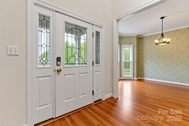 4619 Glasgow Ct, Gastonia, NC 28056 - entryway featuring a chandelier, wood finished floors, crown molding, and wallpapered walls