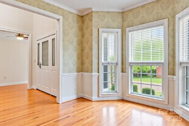 4619 Glasgow Ct, Gastonia, NC 28056 - unfurnished room with light wood-style flooring, plenty of natural light, a wainscoted wall, wallpapered walls, and ornamental molding