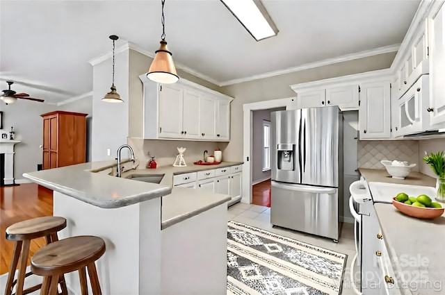 4619 Glasgow Ct, Gastonia, NC 28056 - kitchen featuring white appliances, crown molding, a peninsula, light countertops, and white cabinetry