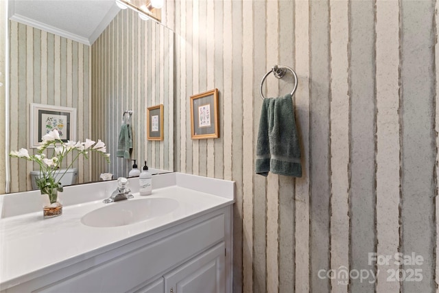 4619 Glasgow Ct, Gastonia, NC 28056 - bathroom featuring wallpapered walls, crown molding, and vanity