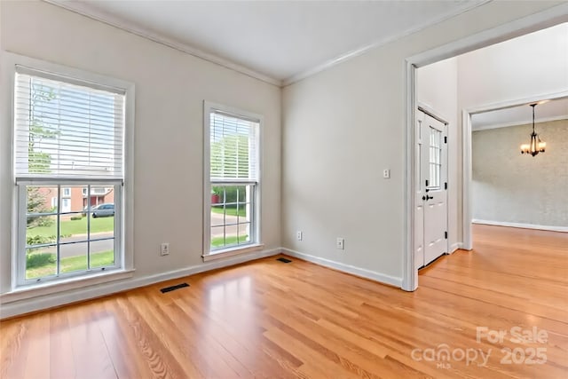 4619 Glasgow Ct, Gastonia, NC 28056 - empty room featuring a chandelier, light wood-style floors, and crown molding