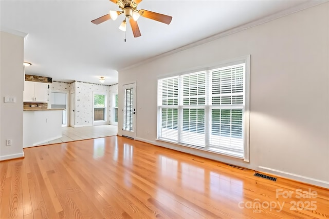 4619 Glasgow Ct, Gastonia, NC 28056 - unfurnished living room featuring light wood-style floors, ornamental molding, and a ceiling fan