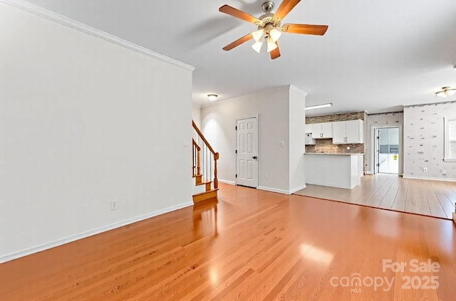 4619 Glasgow Ct, Gastonia, NC 28056 - unfurnished living room featuring light wood finished floors, ceiling fan, stairway, and ornamental molding