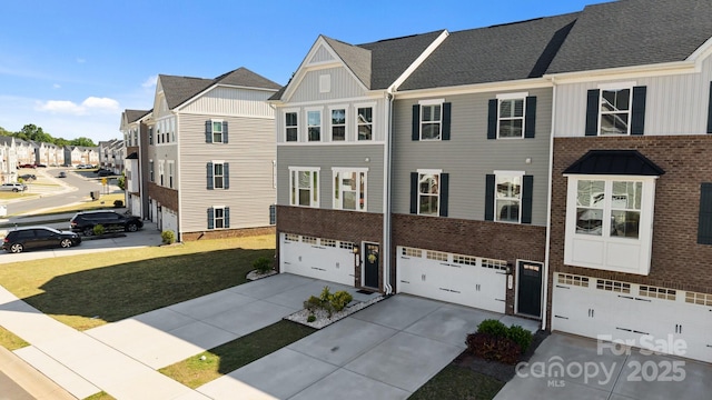 2665 Grantham Place Dr, Fort Mill, SC 29715 - townhome / multi-family property featuring board and batten siding, concrete driveway, a garage, a residential view, and brick siding