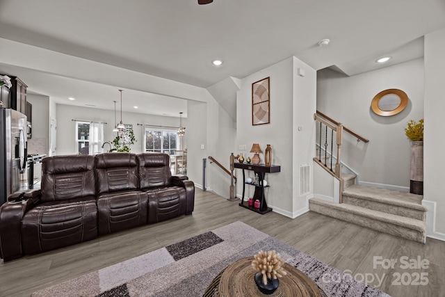 2665 Grantham Place Dr, Fort Mill, SC 29715 - living room featuring wood finished floors, recessed lighting, a chandelier, and stairway