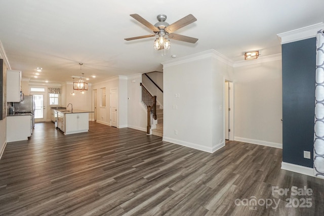110 Synandra Dr Unit B, Mooresville, NC 28117 - unfurnished living room featuring crown molding, ceiling fan, stairs, dark wood-style floors, and a chandelier
