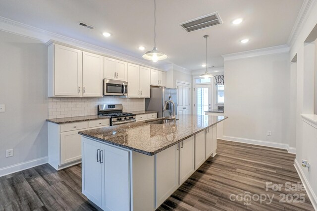 110 Synandra Dr Unit B, Mooresville, NC 28117 - kitchen featuring appliances with stainless steel finishes, a sink, dark wood-type flooring, ornamental molding, and baseboards