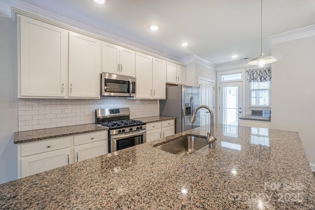110 Synandra Dr Unit B, Mooresville, NC 28117 - kitchen with appliances with stainless steel finishes, a sink, ornamental molding, backsplash, and white cabinets