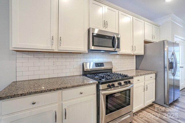 110 Synandra Dr Unit B, Mooresville, NC 28117 - kitchen with stainless steel appliances, light wood-type flooring, stone countertops, crown molding, and backsplash