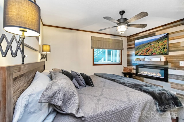 301 Pinnacle Inn Rd Unit 2210, Beech Mountain, NC 28604 - bedroom with crown molding, a glass covered fireplace, a ceiling fan, and a textured ceiling