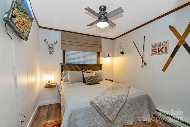 301 Pinnacle Inn Rd Unit 2210, Beech Mountain, NC 28604 - bedroom featuring a baseboard heating unit, wood finished floors, crown molding, a ceiling fan, and baseboards