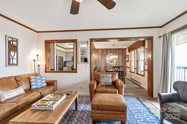 301 Pinnacle Inn Rd Unit 2210, Beech Mountain, NC 28604 - living room with baseboard heating, ornamental molding, ceiling fan, wood finished floors, and baseboards