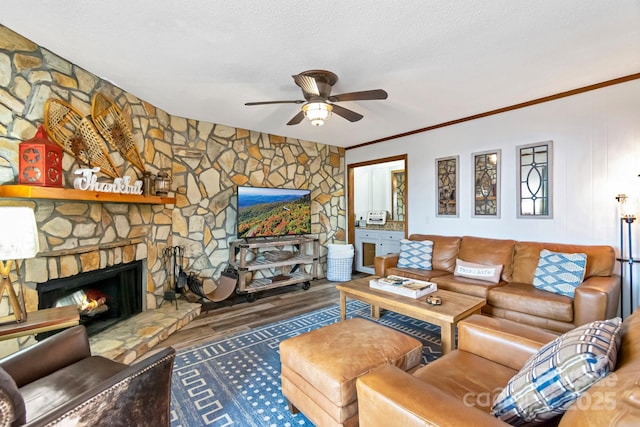 301 Pinnacle Inn Rd Unit 2210, Beech Mountain, NC 28604 - living room featuring a ceiling fan, wood finished floors, ornamental molding, a stone fireplace, and a textured ceiling