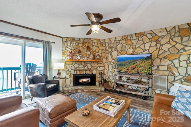 301 Pinnacle Inn Rd Unit 2210, Beech Mountain, NC 28604 - living area featuring a ceiling fan, a fireplace, wood finished floors, a textured ceiling, and crown molding
