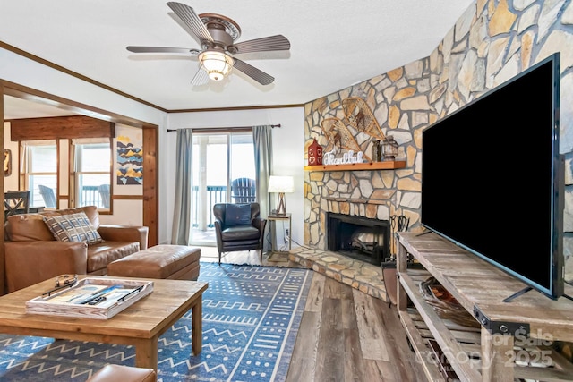 301 Pinnacle Inn Rd Unit 2210, Beech Mountain, NC 28604 - living area featuring wood finished floors, a stone fireplace, ceiling fan, and crown molding