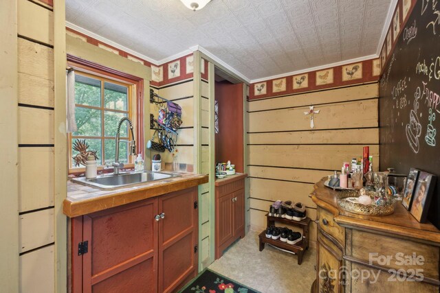 214 Hubert Mccall Rd, Balsam Grove, NC 28708 - kitchen featuring a sink, tile countertops, ornamental molding, an ornate ceiling, and wood walls