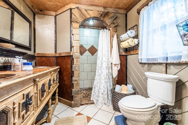 214 Hubert Mccall Rd, Balsam Grove, NC 28708 - bathroom featuring a tile shower, toilet, tile patterned floors, and double vanity