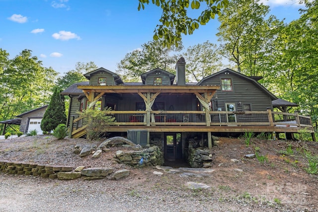 214 Hubert Mccall Rd, Balsam Grove, NC 28708 - rear view of house featuring a chimney, a wooden deck, cooling unit, and a garage