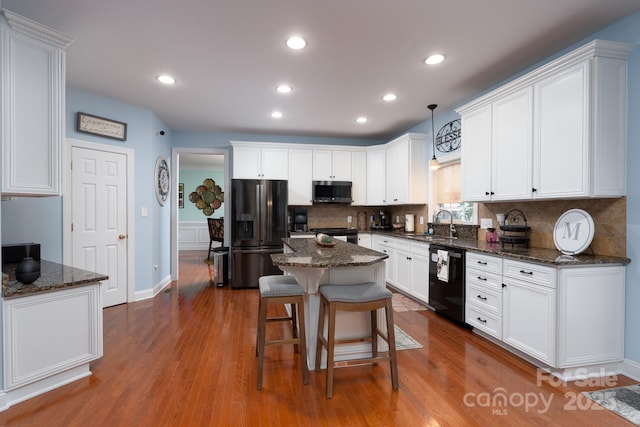 201 Vanderbilt Blvd, Locust, NC 28097 - kitchen with fridge with ice dispenser, black dishwasher, stainless steel microwave, a sink, and decorative backsplash