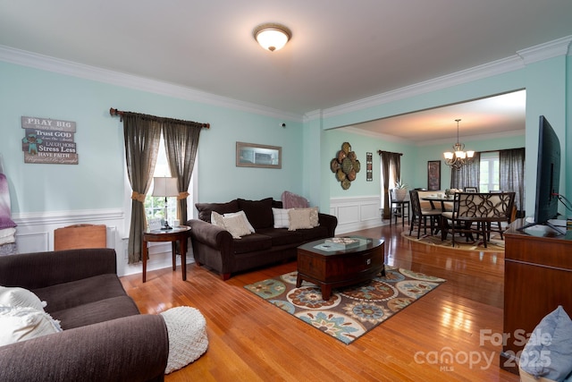 201 Vanderbilt Blvd, Locust, NC 28097 - living room featuring crown molding, a chandelier, wainscoting, and wood finished floors