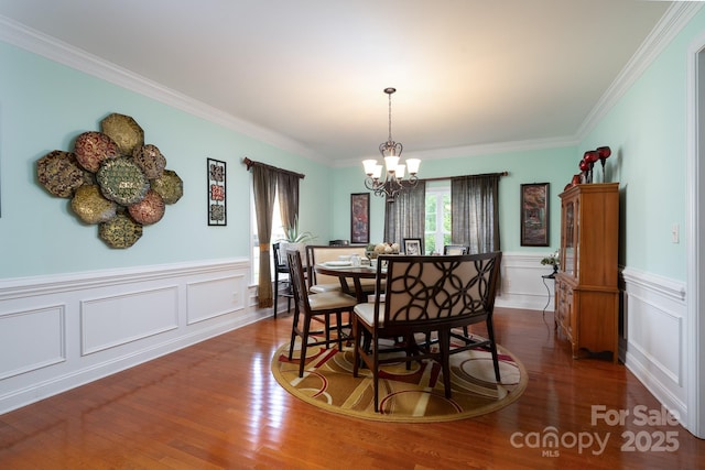 201 Vanderbilt Blvd, Locust, NC 28097 - dining room with a chandelier, wood finished floors, wainscoting, ornamental molding, and a decorative wall
