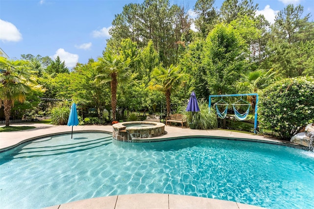 5418 Commodore Pl, Clover, SC 29710 - view of swimming pool with view of wooded area and a pool with connected hot tub