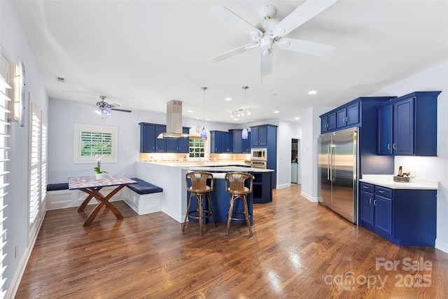 5418 Commodore Pl, Clover, SC 29710 - kitchen with built in appliances, blue cabinets, island range hood, ceiling fan, and recessed lighting