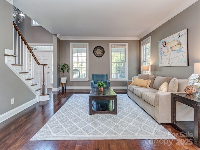 living area featuring hardwood / wood-style floors, baseboards, stairs, and crown molding