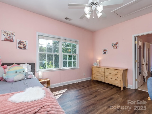 bedroom featuring attic access, dark wood finished floors, baseboards, and a ceiling fan