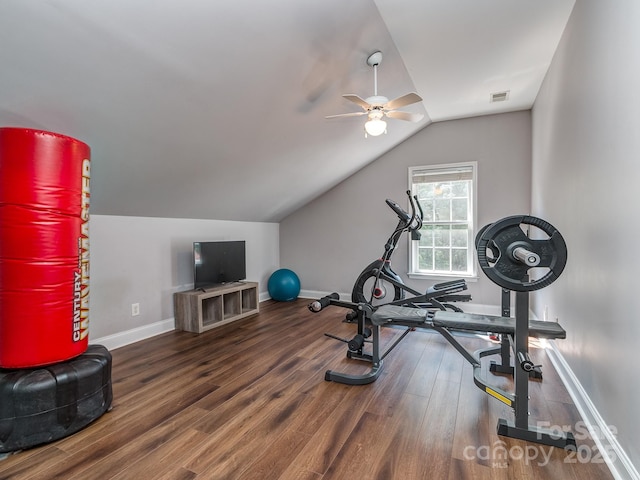 exercise area featuring ceiling fan, baseboards, wood finished floors, and vaulted ceiling