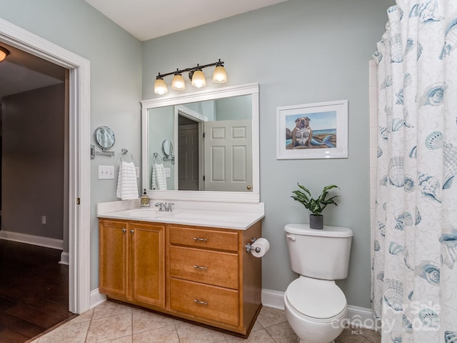 bathroom featuring vanity, toilet, baseboards, and a shower with shower curtain