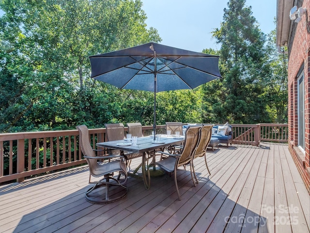 wooden deck featuring outdoor dining space