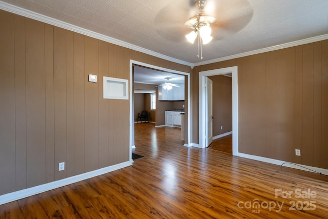 205 Stowe Acres Rd, Kings Mountain, NC 28086 - empty room featuring ceiling fan, wood finished floors, crown molding, and baseboards