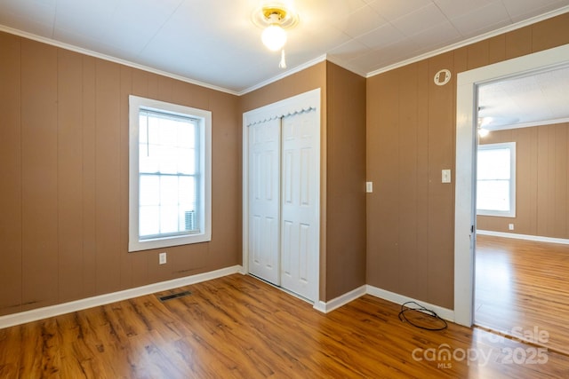 205 Stowe Acres Rd, Kings Mountain, NC 28086 - unfurnished bedroom featuring crown molding, wood finished floors, a closet, and baseboards