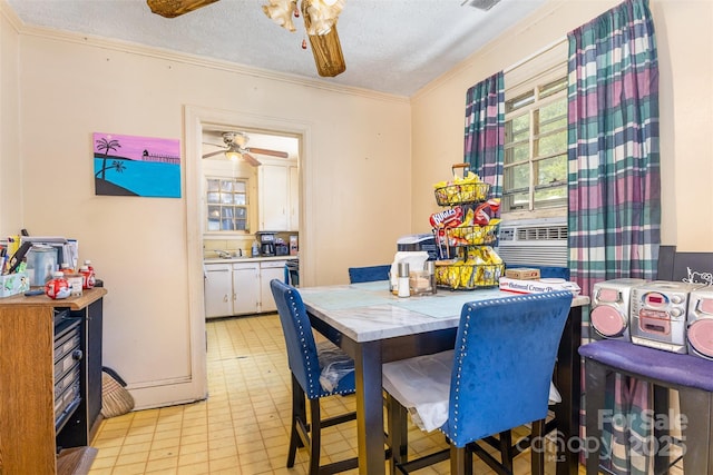 dining room with ornamental molding, a ceiling fan, a textured ceiling, and cooling unit
