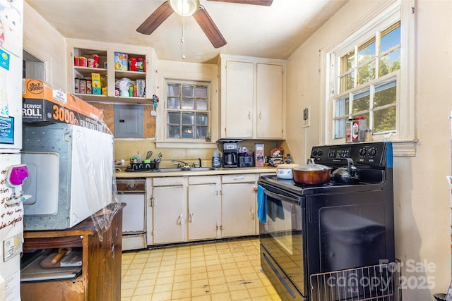 kitchen featuring black electric range, dishwasher, a sink, and white cabinets