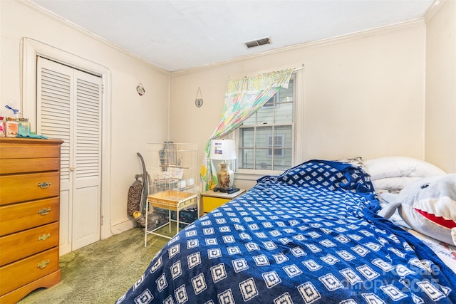 carpeted bedroom featuring ornamental molding and a closet