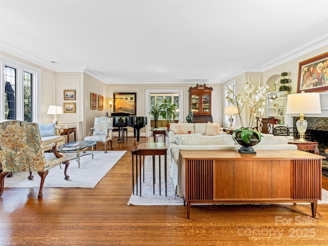 living room with wood finished floors and ornamental molding