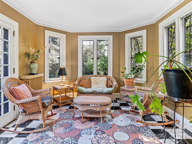 sunroom / solarium with plenty of natural light, crown molding, french doors, and baseboards