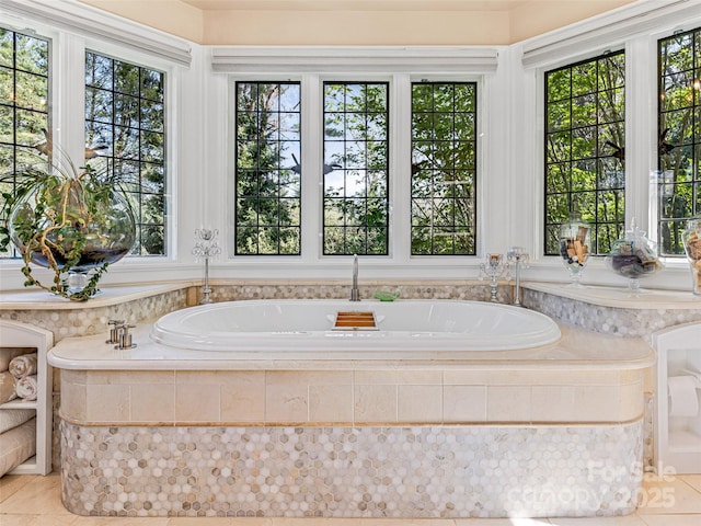 full bathroom featuring tile patterned flooring, plenty of natural light, and a bath