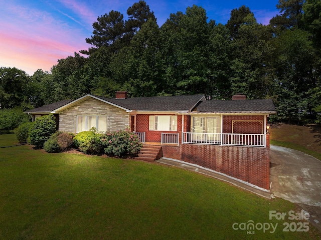 24501 Canton Rd, Albemarle, NC 28001 - single story home featuring a chimney, brick siding, covered porch, and a front yard