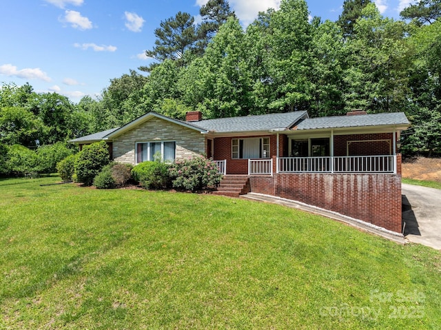 24501 Canton Rd, Albemarle, NC 28001 - single story home featuring a chimney, a porch, a front lawn, and brick siding