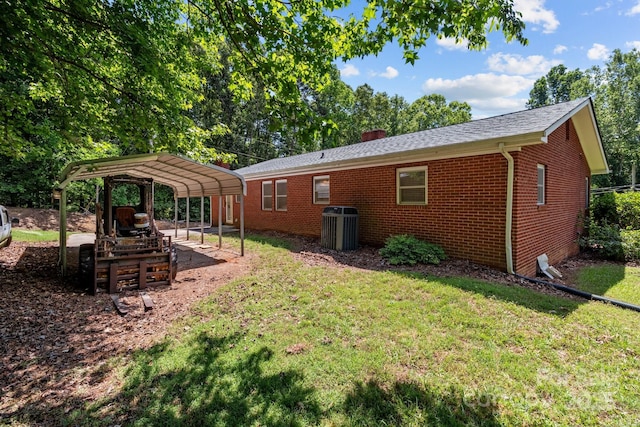 24501 Canton Rd, Albemarle, NC 28001 - rear view of property featuring a carport, brick siding, a yard, a chimney, and central AC unit