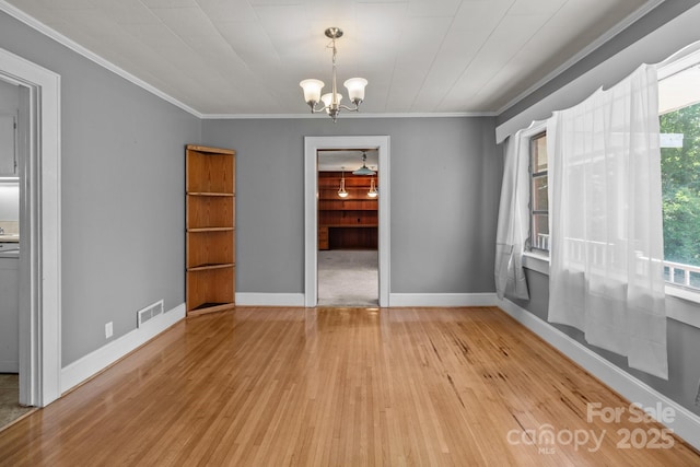 24501 Canton Rd, Albemarle, NC 28001 - unfurnished dining area with light wood finished floors, ornamental molding, a chandelier, and baseboards