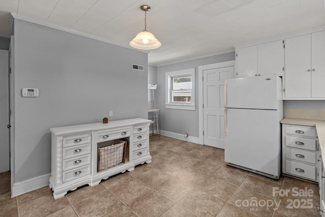 24501 Canton Rd, Albemarle, NC 28001 - kitchen featuring freestanding refrigerator, crown molding, white cabinets, light countertops, and baseboards