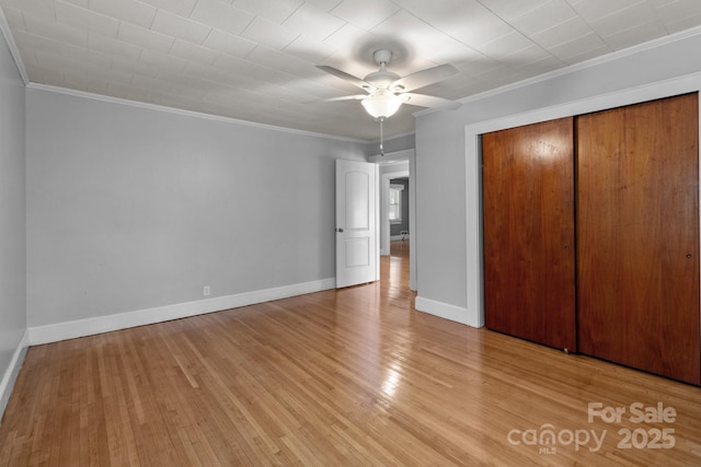 24501 Canton Rd, Albemarle, NC 28001 - unfurnished bedroom featuring ornamental molding, wood finished floors, a closet, baseboards, and a ceiling fan