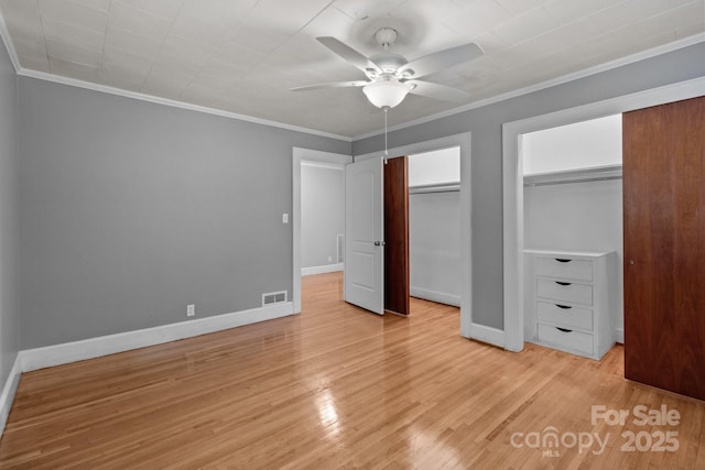 24501 Canton Rd, Albemarle, NC 28001 - unfurnished bedroom featuring multiple closets, ornamental molding, baseboards, light wood finished floors, and a ceiling fan