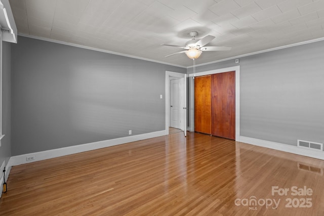 24501 Canton Rd, Albemarle, NC 28001 - unfurnished bedroom with crown molding, baseboards, wood finished floors, a closet, and a ceiling fan